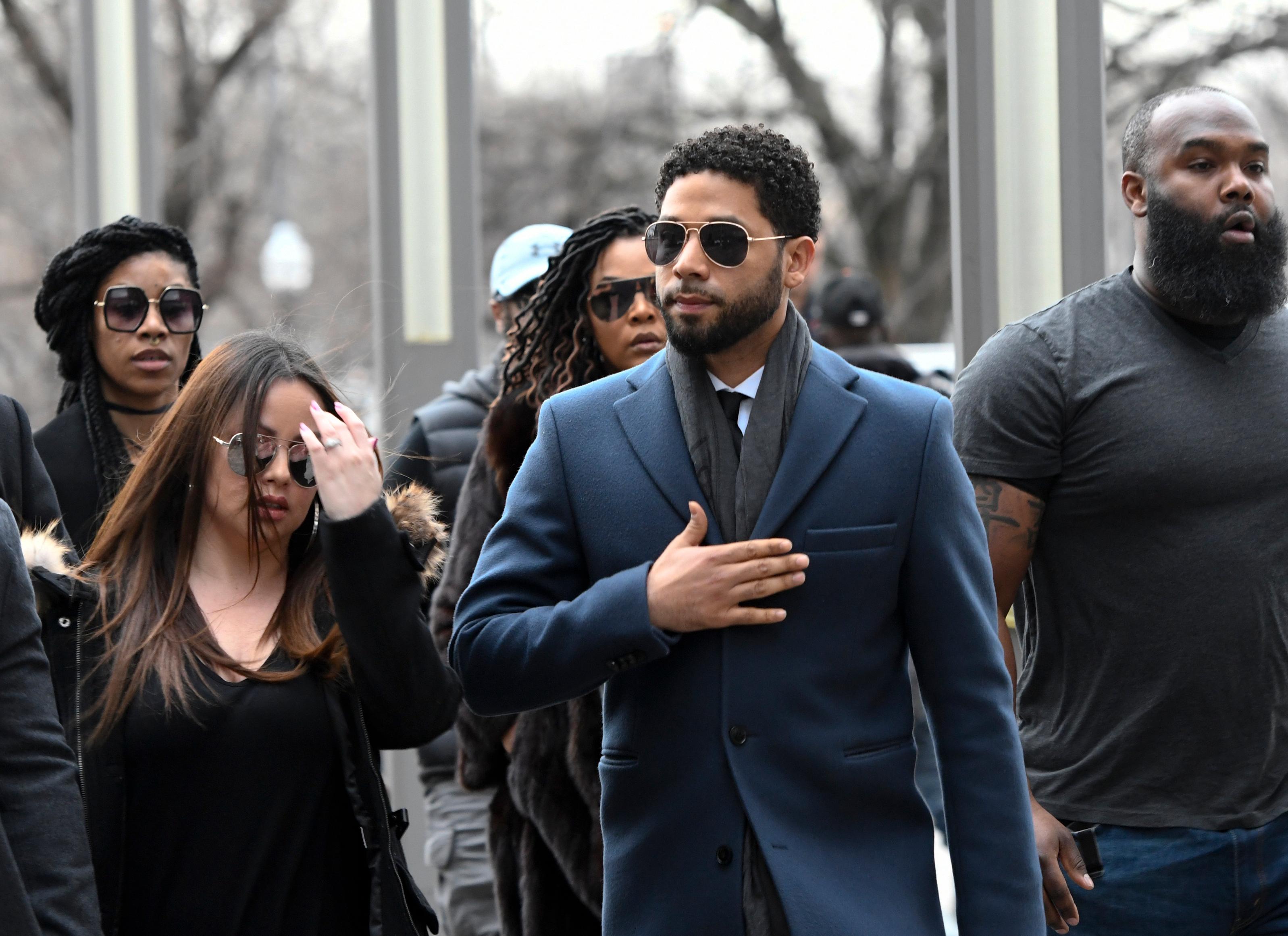 empire actor jussie smollett, center, arrives at the leighton